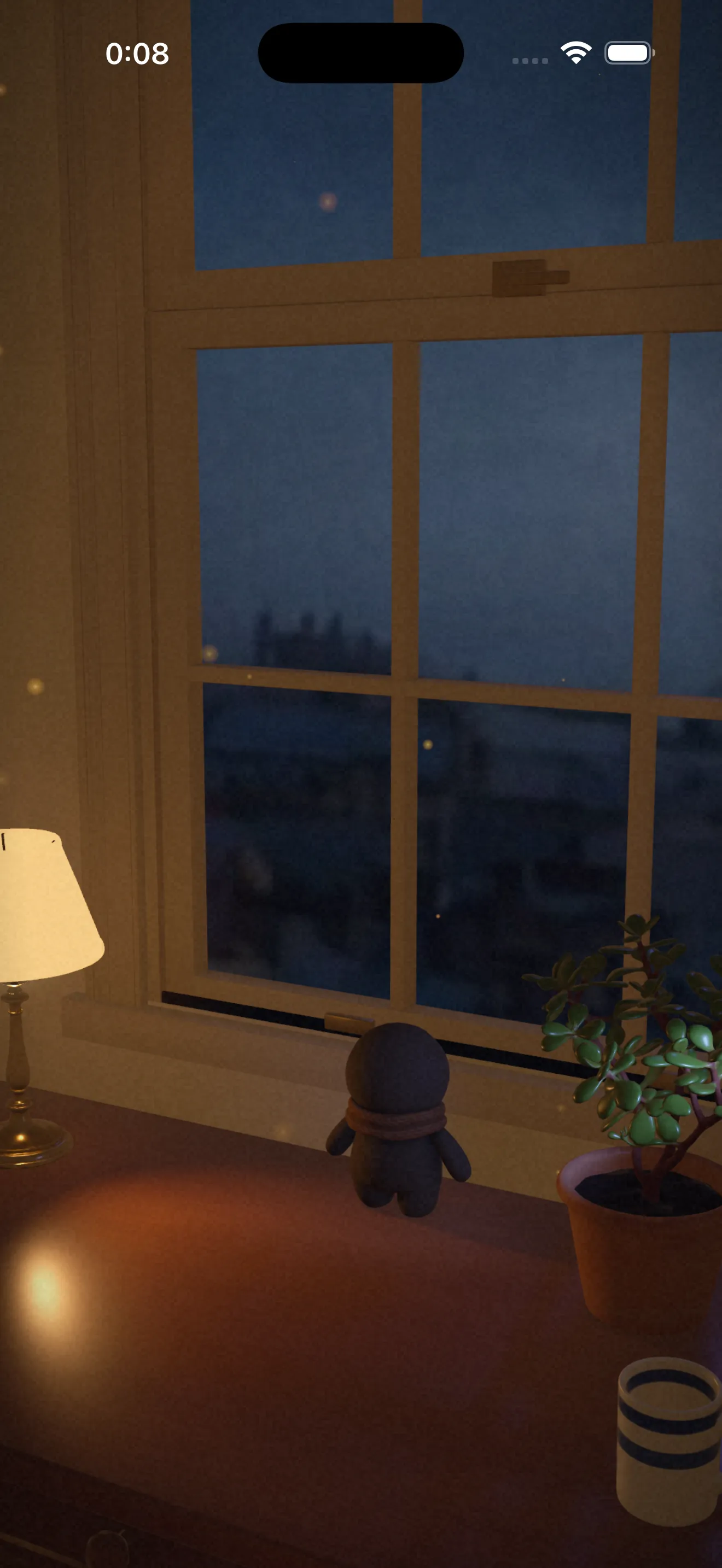 The room at night: the resident stands at the window, a desk lamp lit beside them